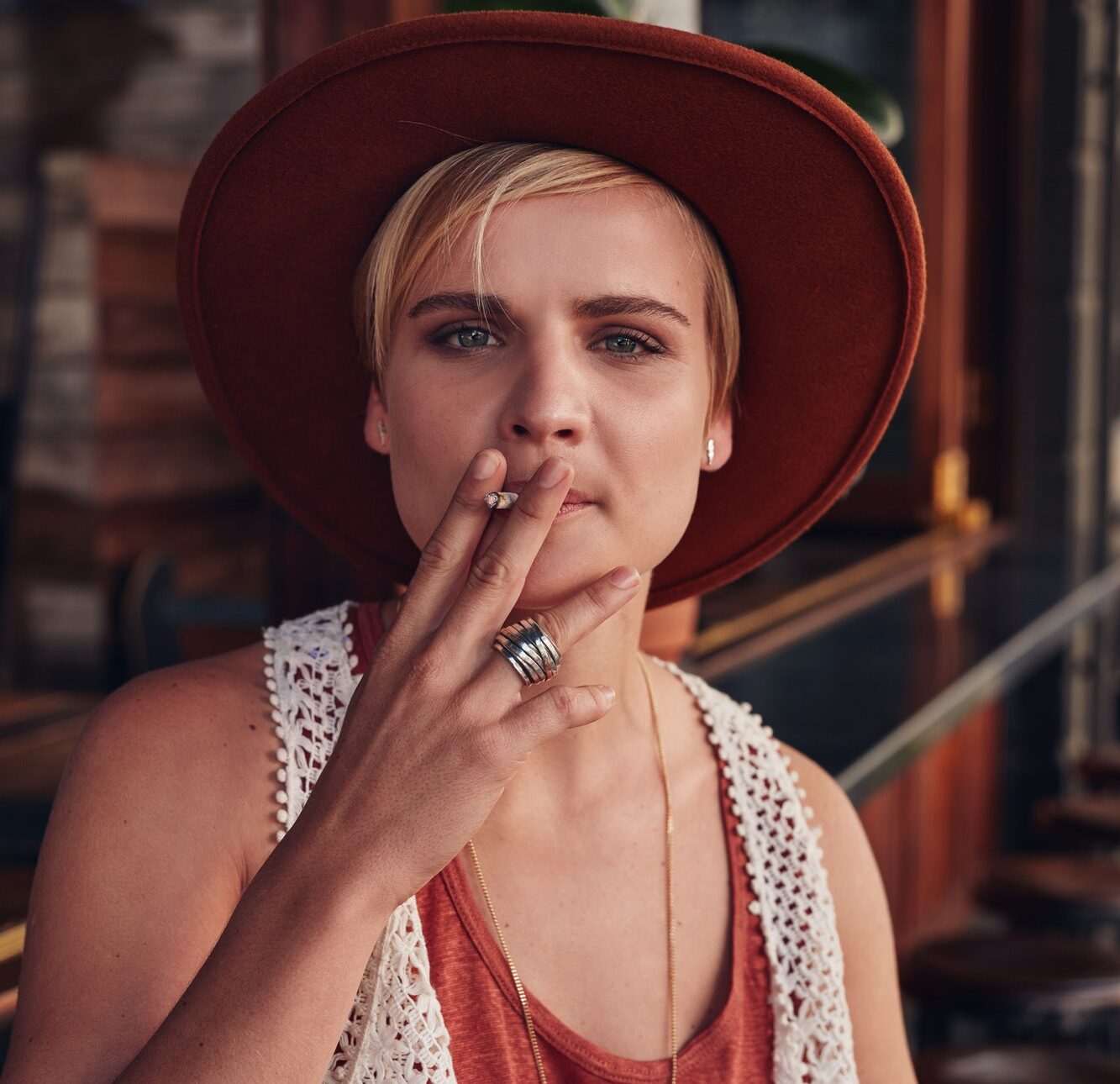 Young woman smoking a cigarette in coffee shop